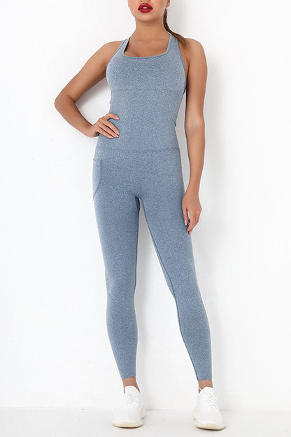 Female model wearing Active Jumpsuit Wide Strap Crisscross Light Blue 