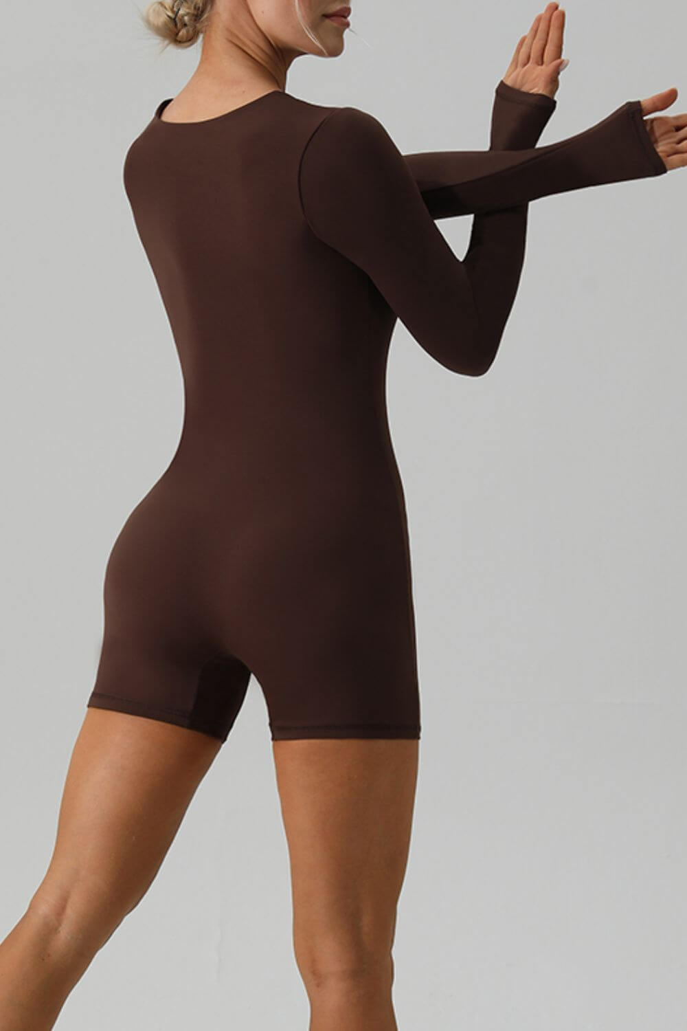 Female model facing backwards wearing Active Romper Square Neck Long Sleeve Brown