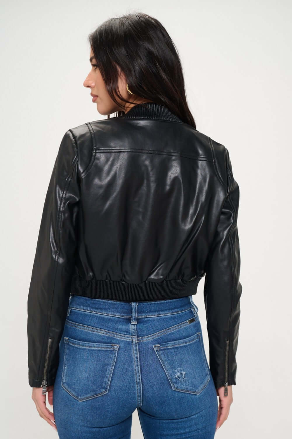 Female model wearing Coalition LA vegan leather cropped bomber jacket black