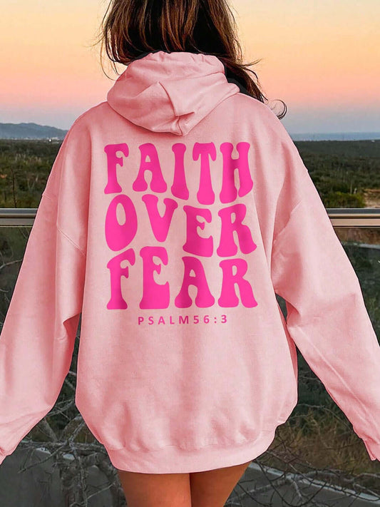 Girl wearing the faith over fear hoodie