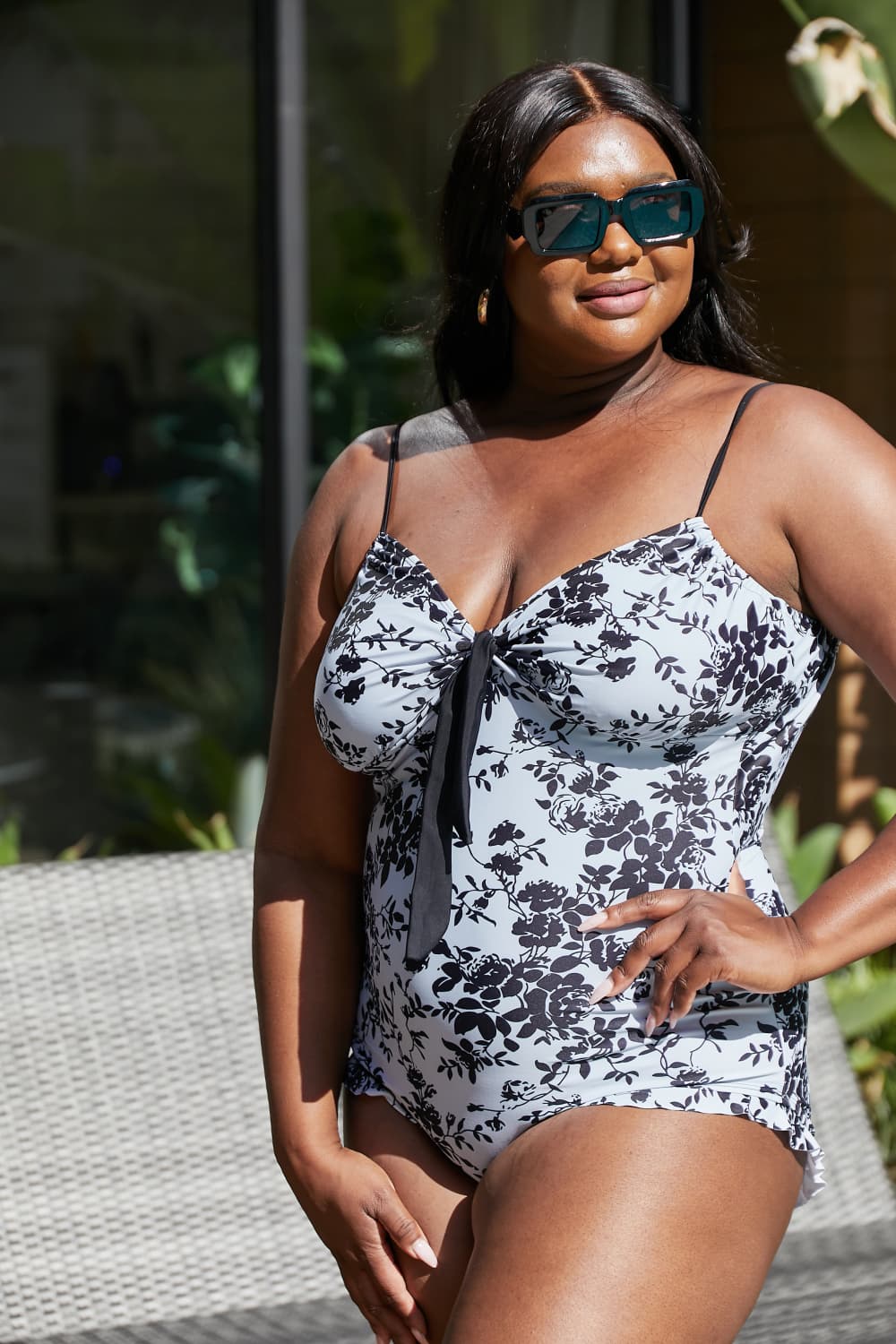 Black model wearing marina west ruffle trim one-piece bathing suit