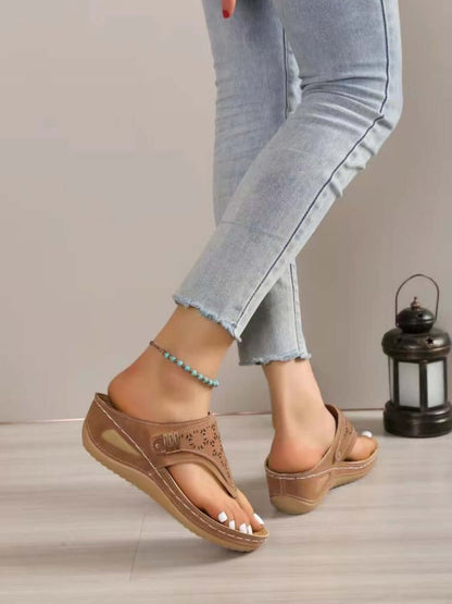 Chic brown slide sandals paired with distressed jeans, perfect for summer outings and stylish comfort.