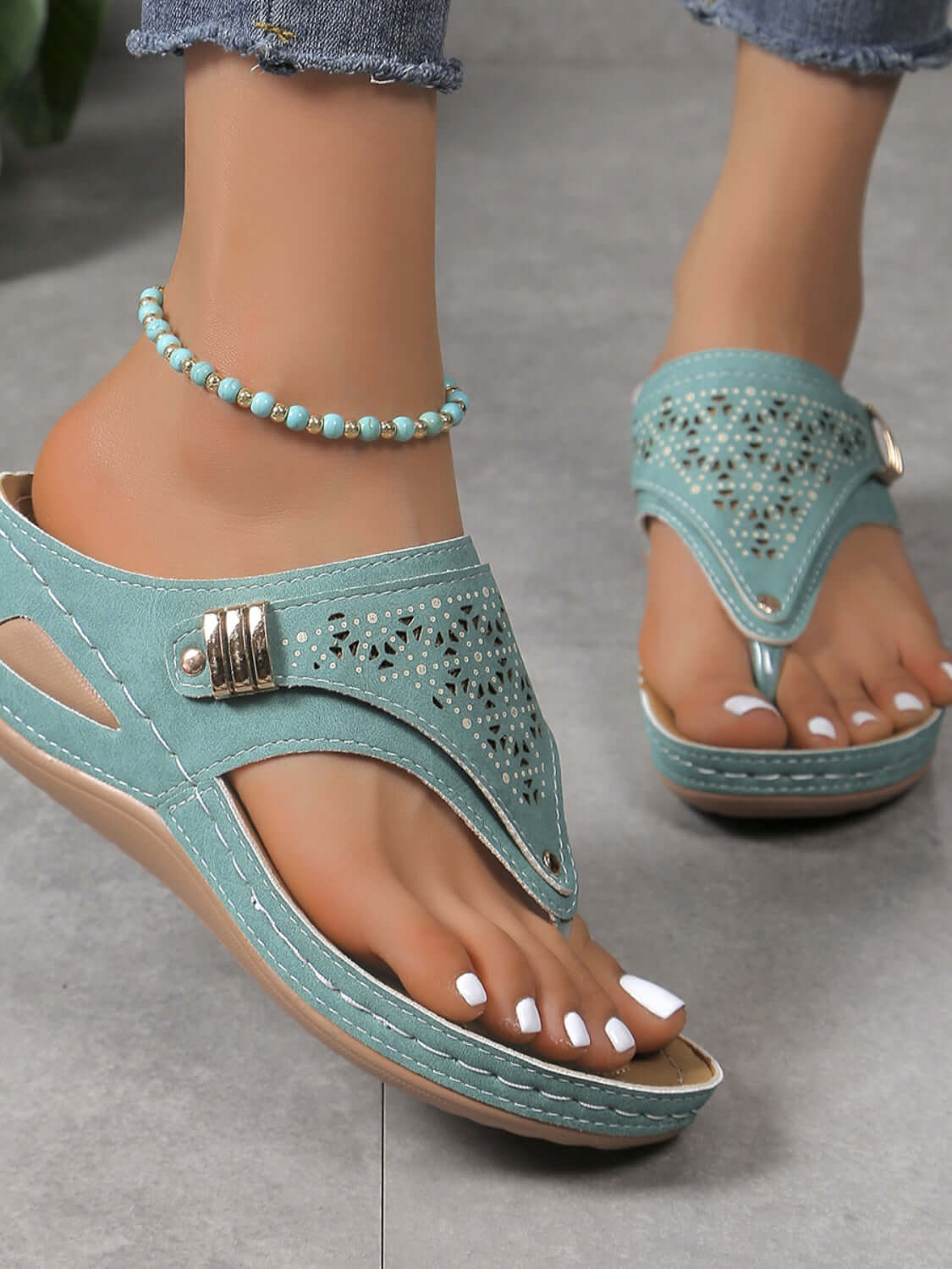 Stylish PVC sandals in soft turquoise, featuring decorative cutouts and a comfy wedge heel, perfect for summer outfits.