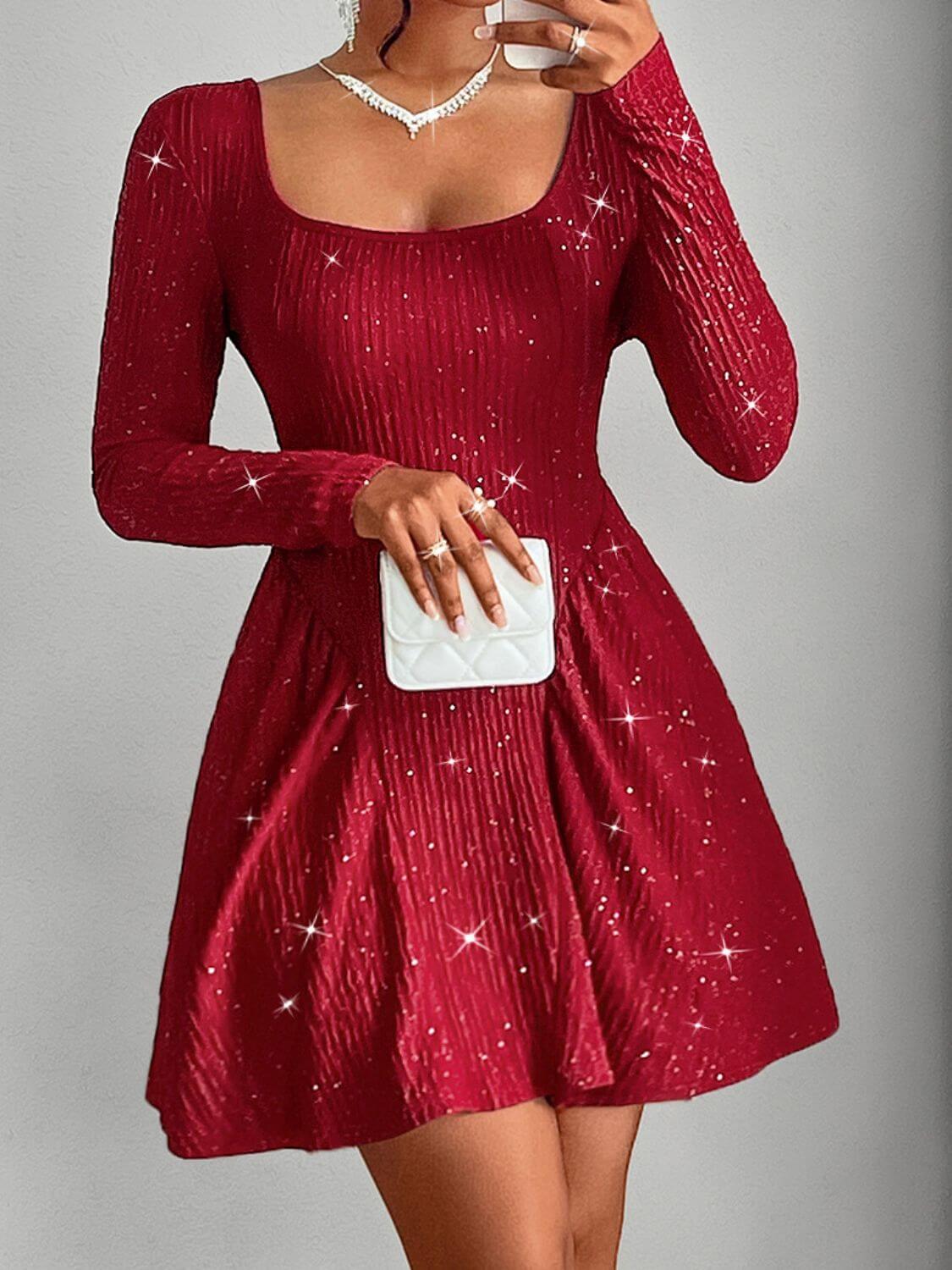 Woman wearing a red sequin mini dress with long sleeves and a chic bag, perfect for glamorous occasions.