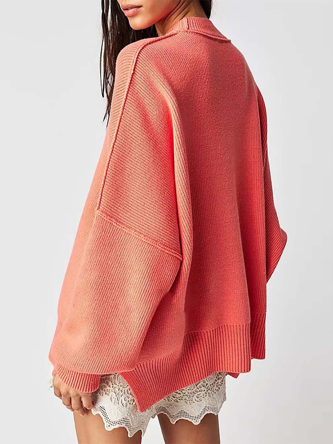 Side view of female model wearing Knit Top Round Neck Long Sleeve Sweater Orange Red