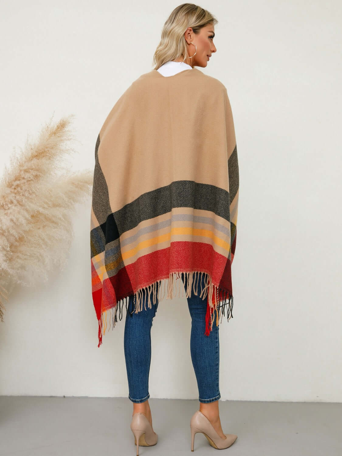 Cozy Fringe Contrast Plaid Poncho in warm tones, perfect for stylish layering on chilly days.